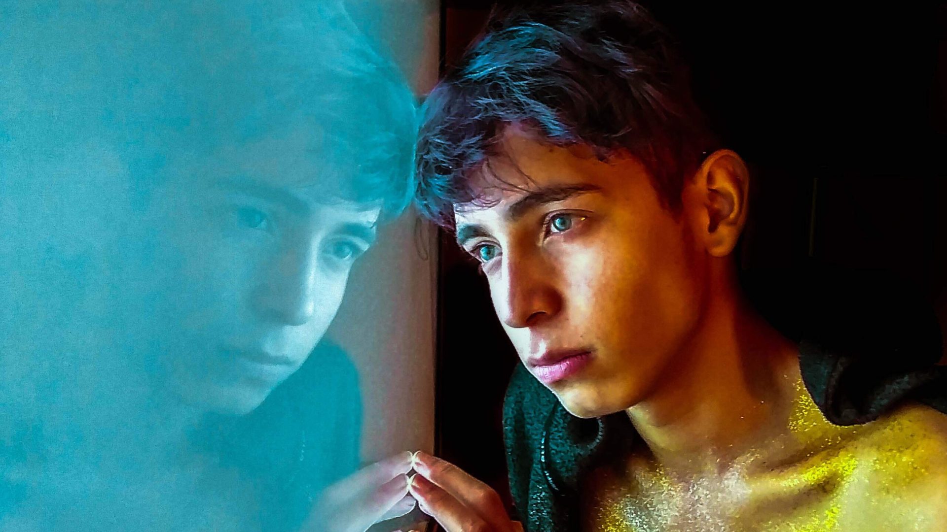 a young man with a pensive look in his eyes